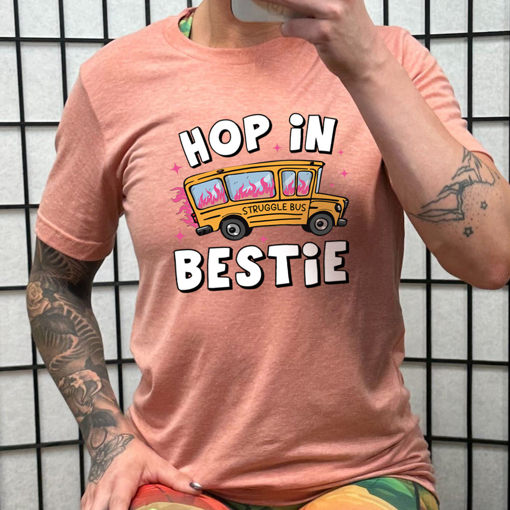 peach shirt with the text "Hop In Bestie" on it