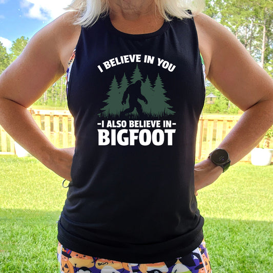 black shirt with the text "I Believe In You I Also Believe In Bigfoot" on it