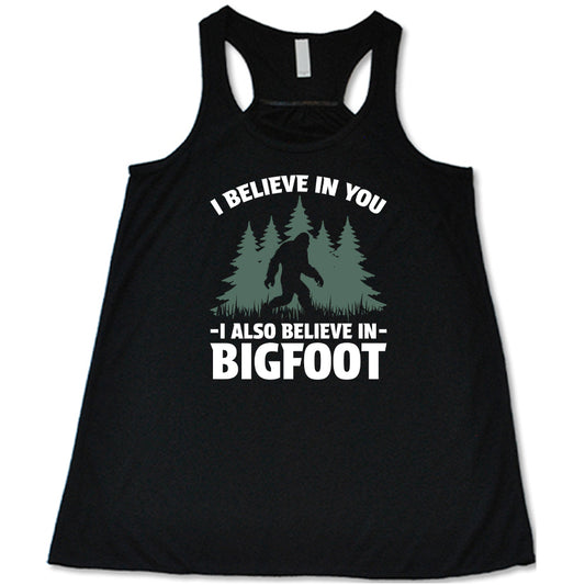 black shirt with the text "I Believe In You I Also Believe In Bigfoot" on it