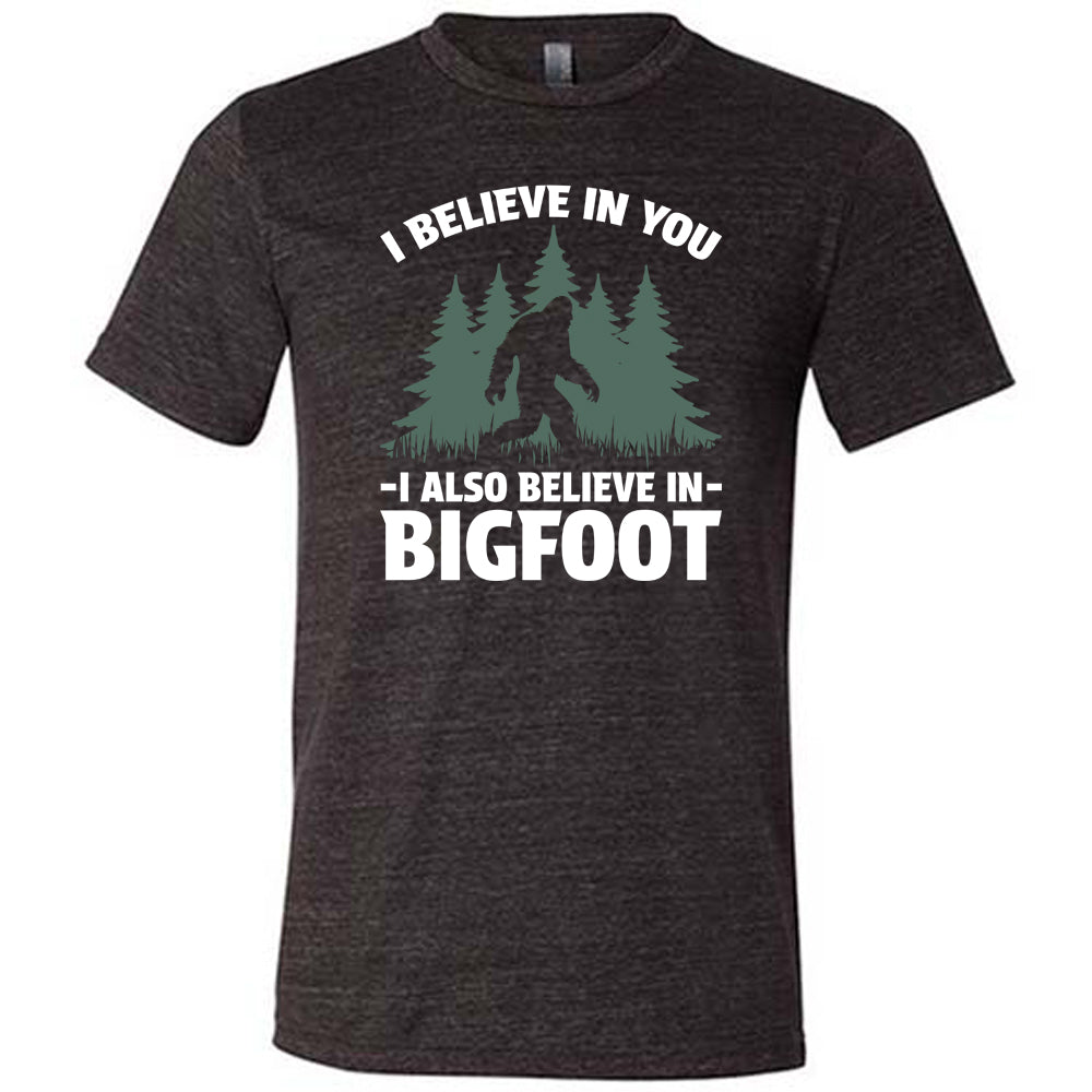 black shirt with the text "I Believe In You I Also Believe In Bigfoot" on it