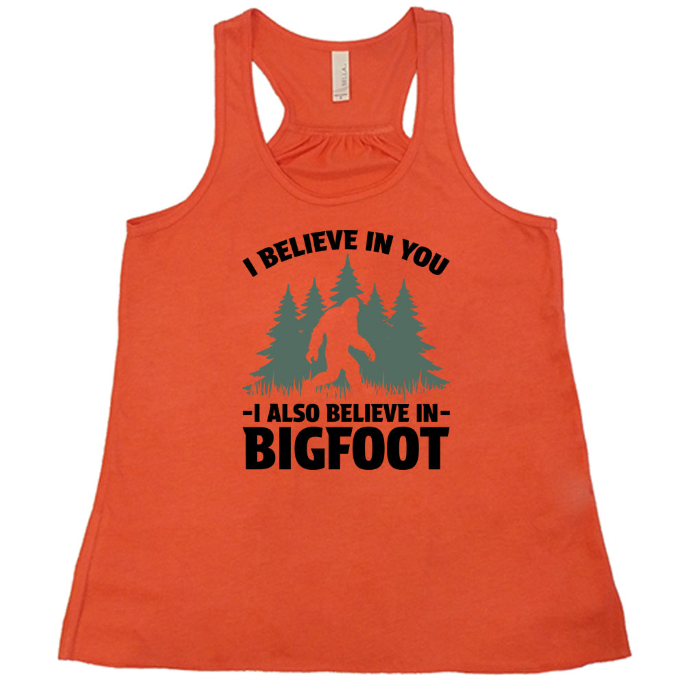 coral shirt with the text "I Believe In You I Also Believe In Bigfoot" on it