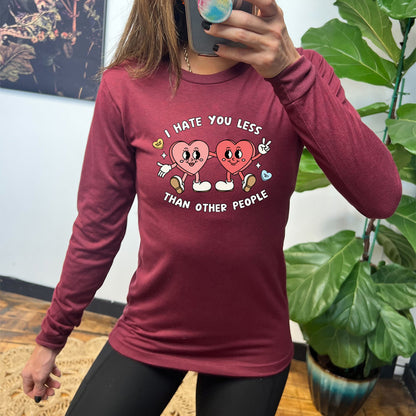 maroon long sleeve shirt with the text "I Hate You Less Than Other People" on it