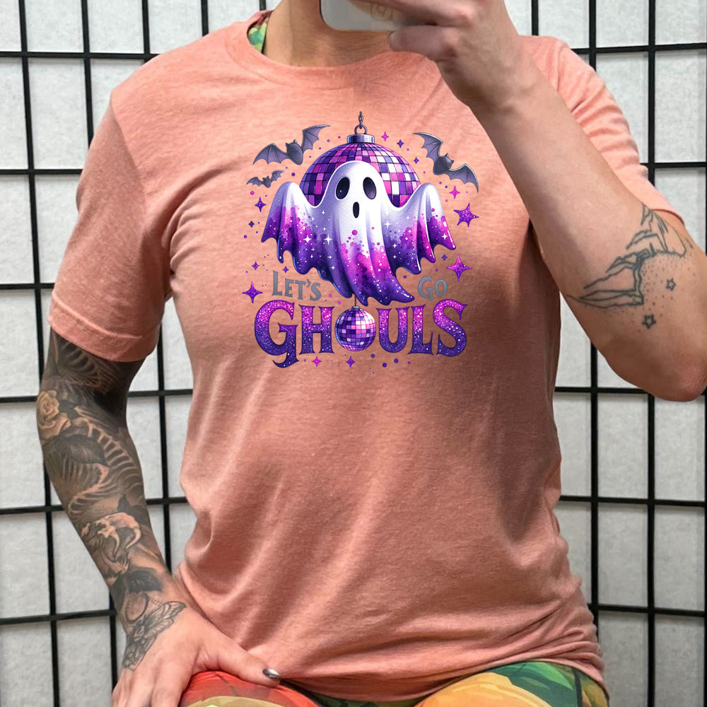 peach shirt that has a ghost graphic on it with the text "Let's Go Ghouls" on it