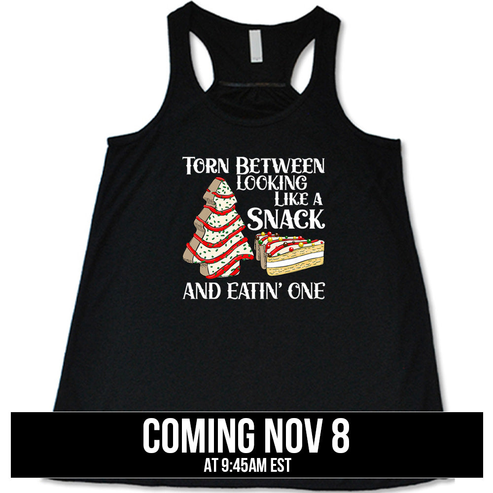 shirt with the text "Torn Between Looking Like A Snack And Eating One" on it coming soon