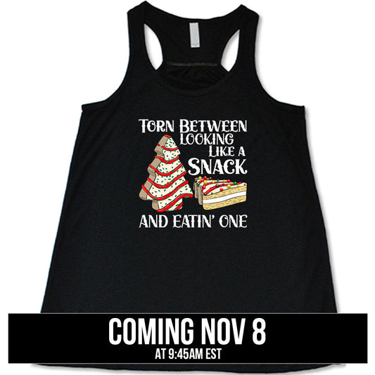 shirt with the text "Torn Between Looking Like A Snack And Eating One" on it coming soon