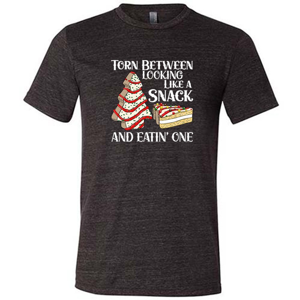 black shirt with the text "Torn Between Looking Like A Snack And Eating One" on it