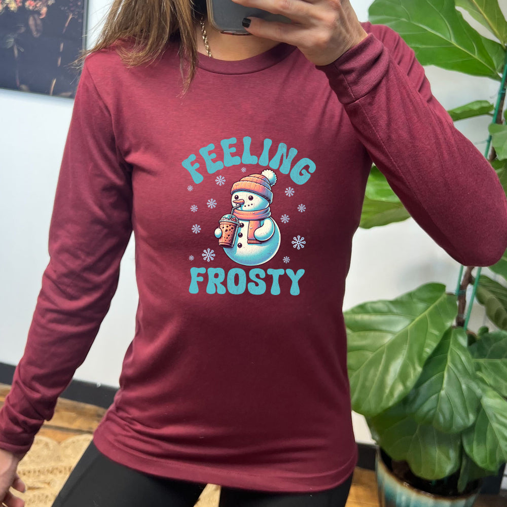 maroon long sleeve shirt with the text "Feelin Frosty" and a snowman graphic on it