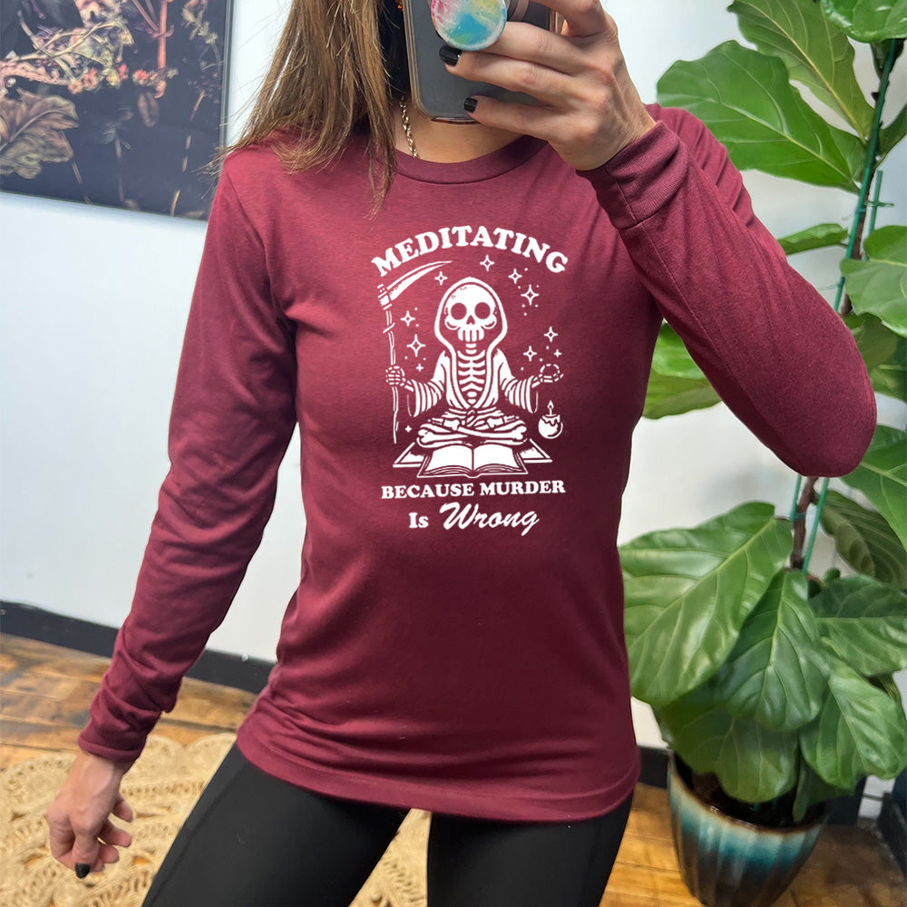 maroon long sleeve shirt with the text "Meditating Because Murder is Wrong" on it