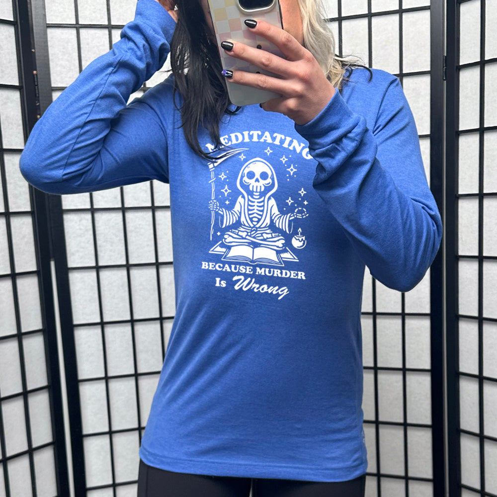 blue long sleeve shirt with the text "Meditating Because Murder is Wrong" on it