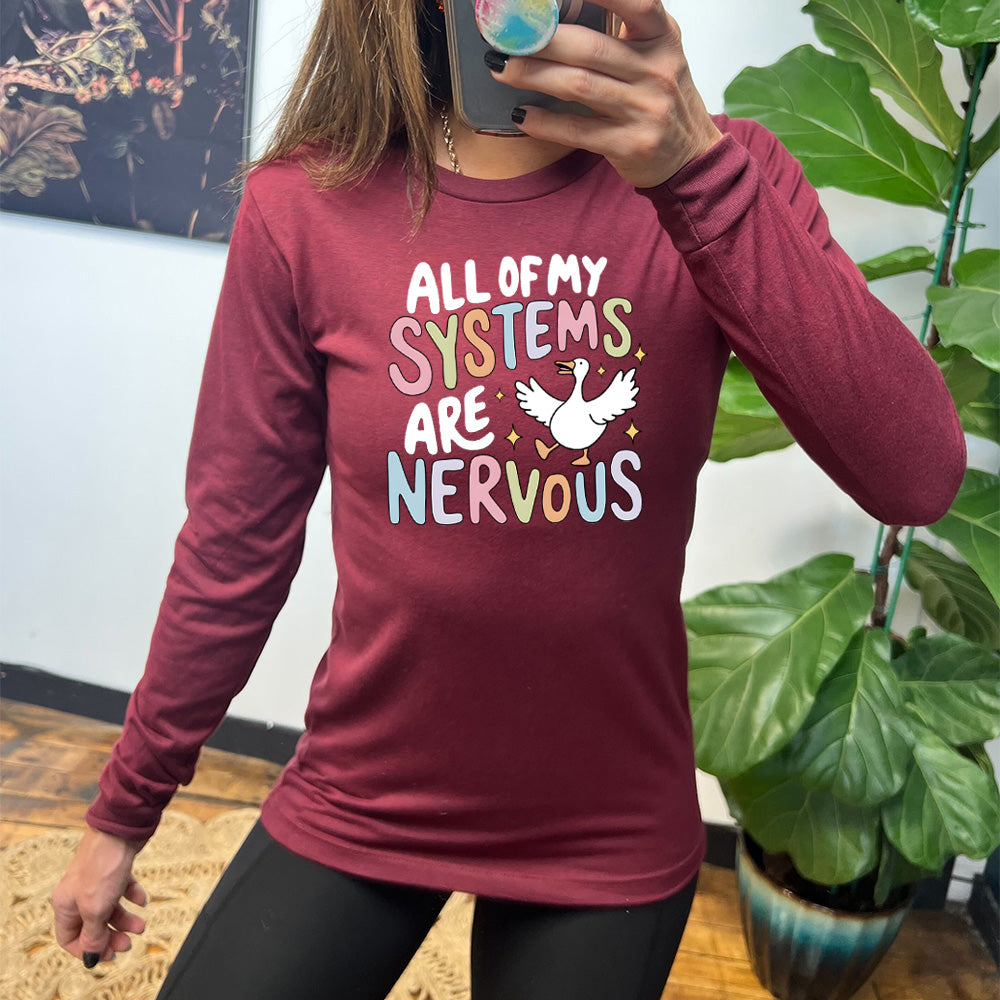 maroon shirt with the text "All Of My Systems Are Nervous" on it