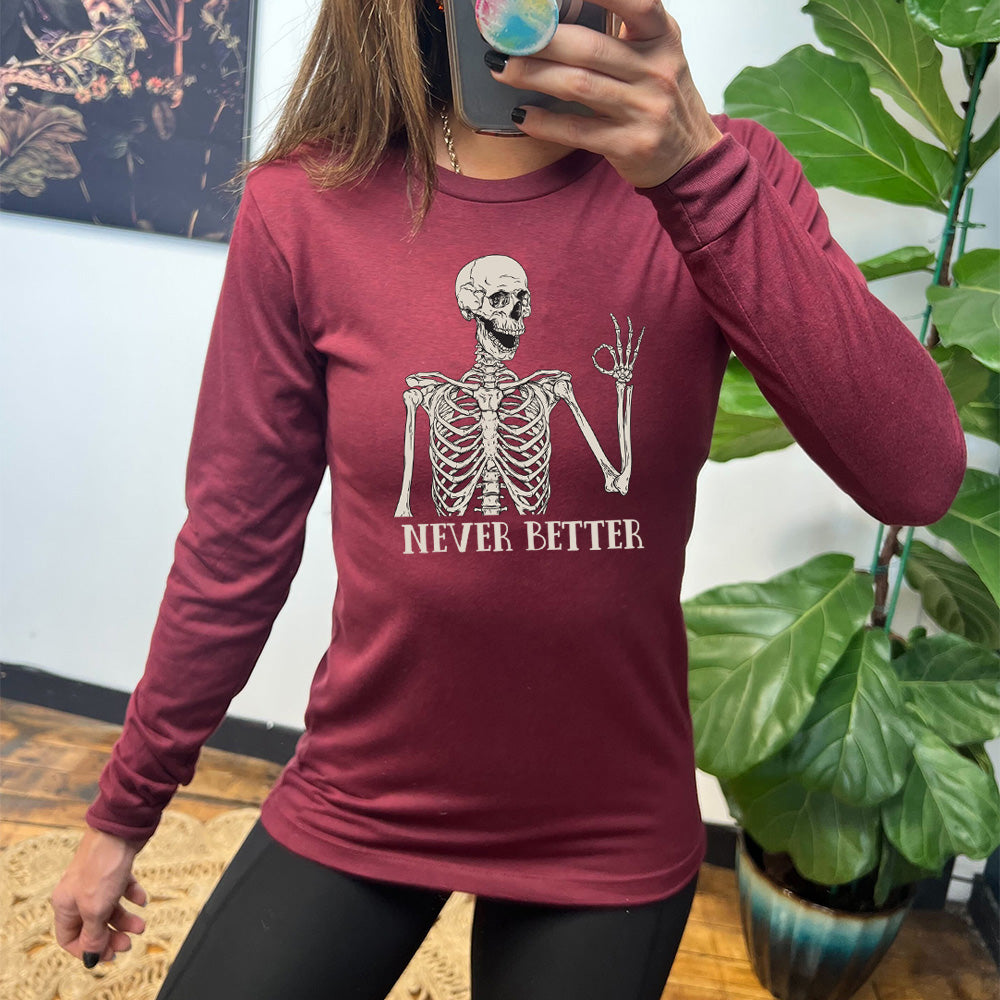 maroon shirt with the text "Never Better" and a skeleton graphic on it