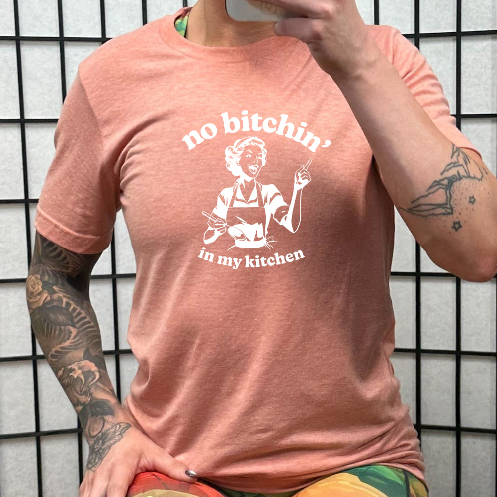 peach shirt with the text "No Bitchin In My Kitchen" on it