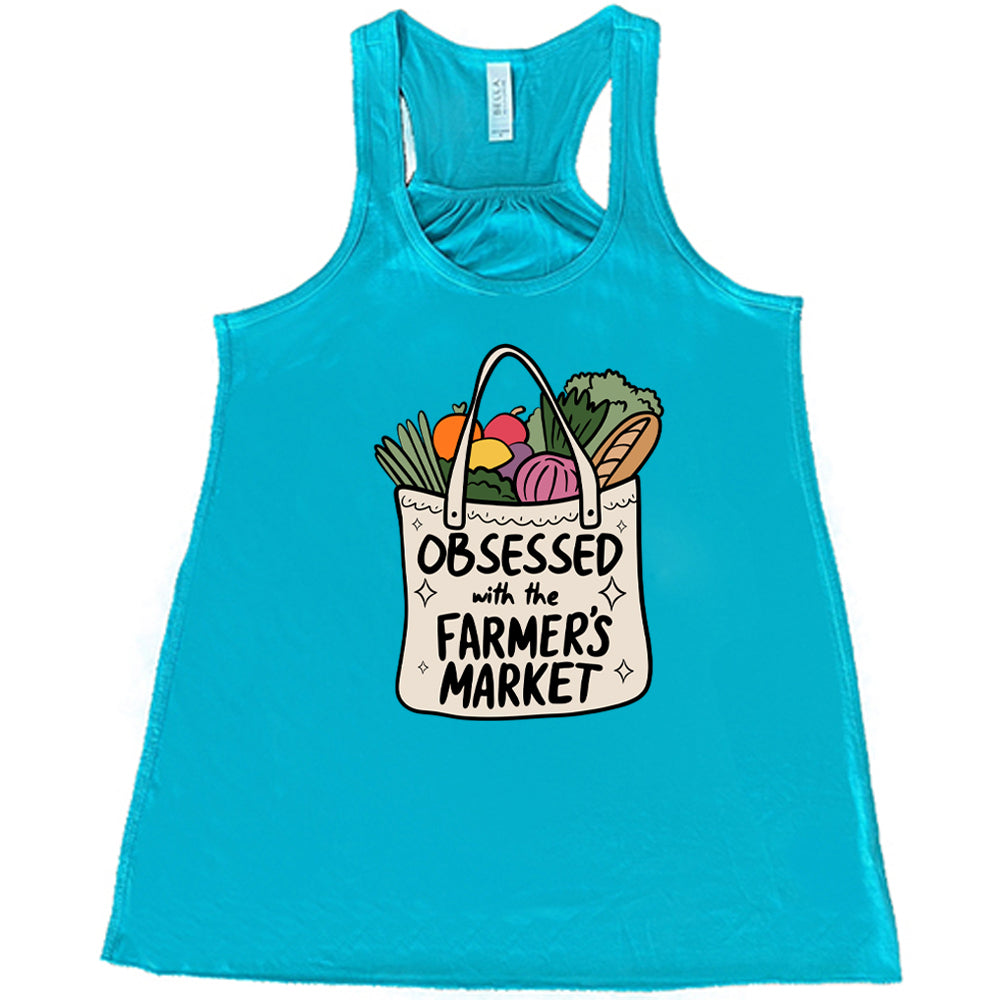 teal shirt with the text "Obsessed With The Farmer's Market" on it