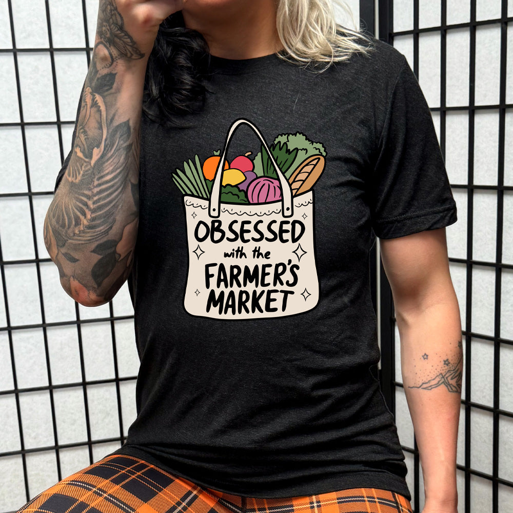 black shirt with the text "Obsessed With The Farmer's Market" on it