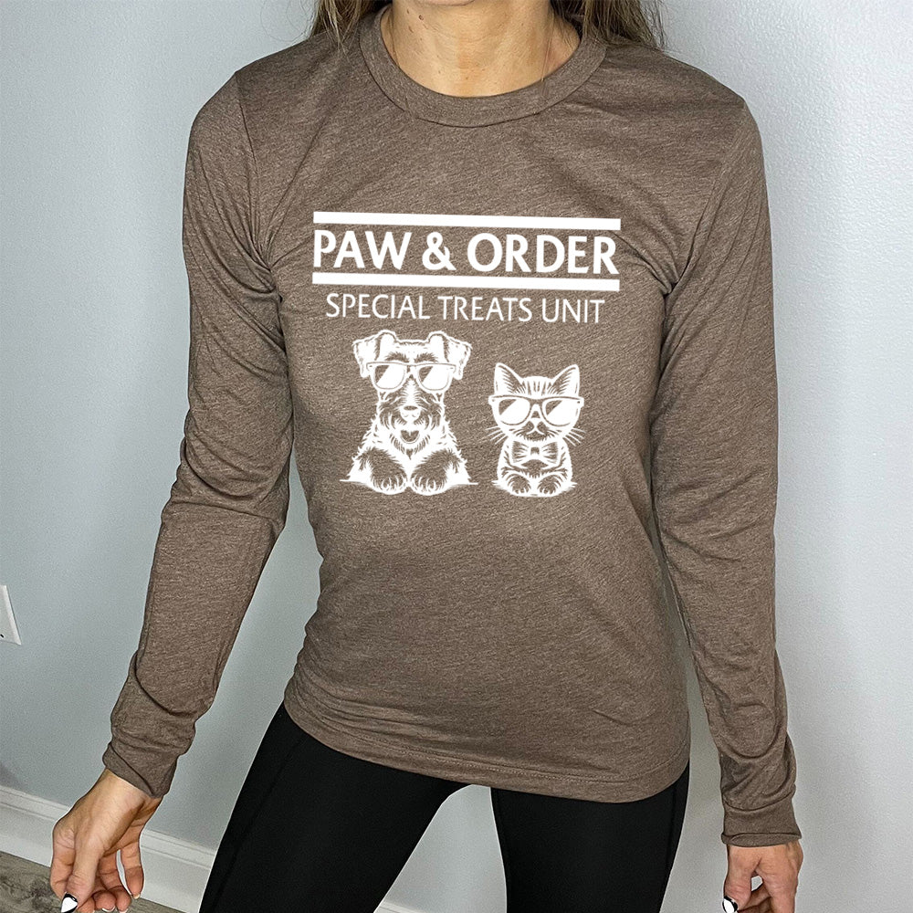 brown shirt with the text "Paw & Order" and a graphic of a cat and dog on it