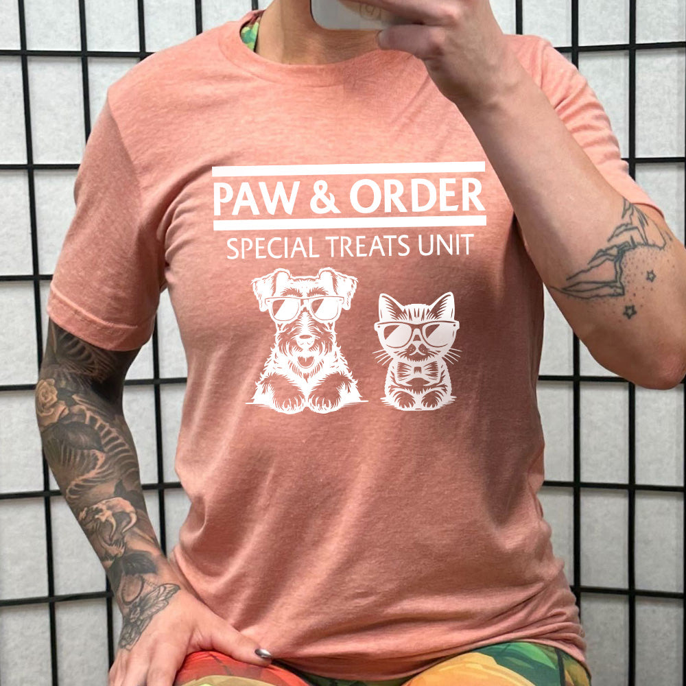 peach shirt with the text "Paw & Order" and a graphic of a cat and dog on it