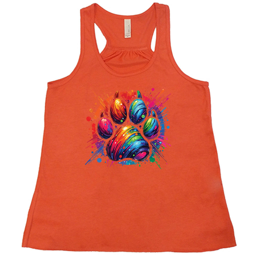 coral shirt with a rainbow paw print graphic on it