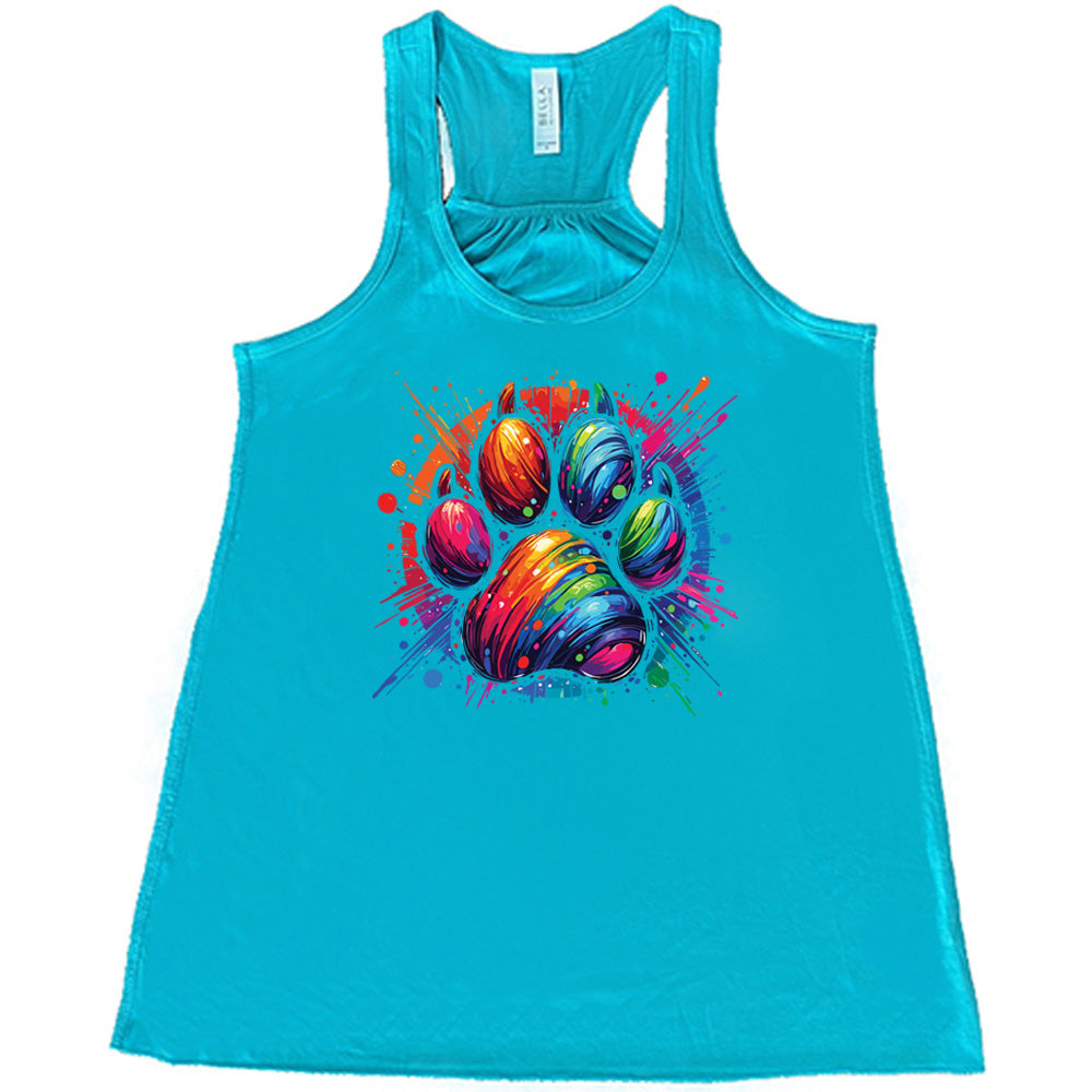 teal shirt with a rainbow paw print graphic on it