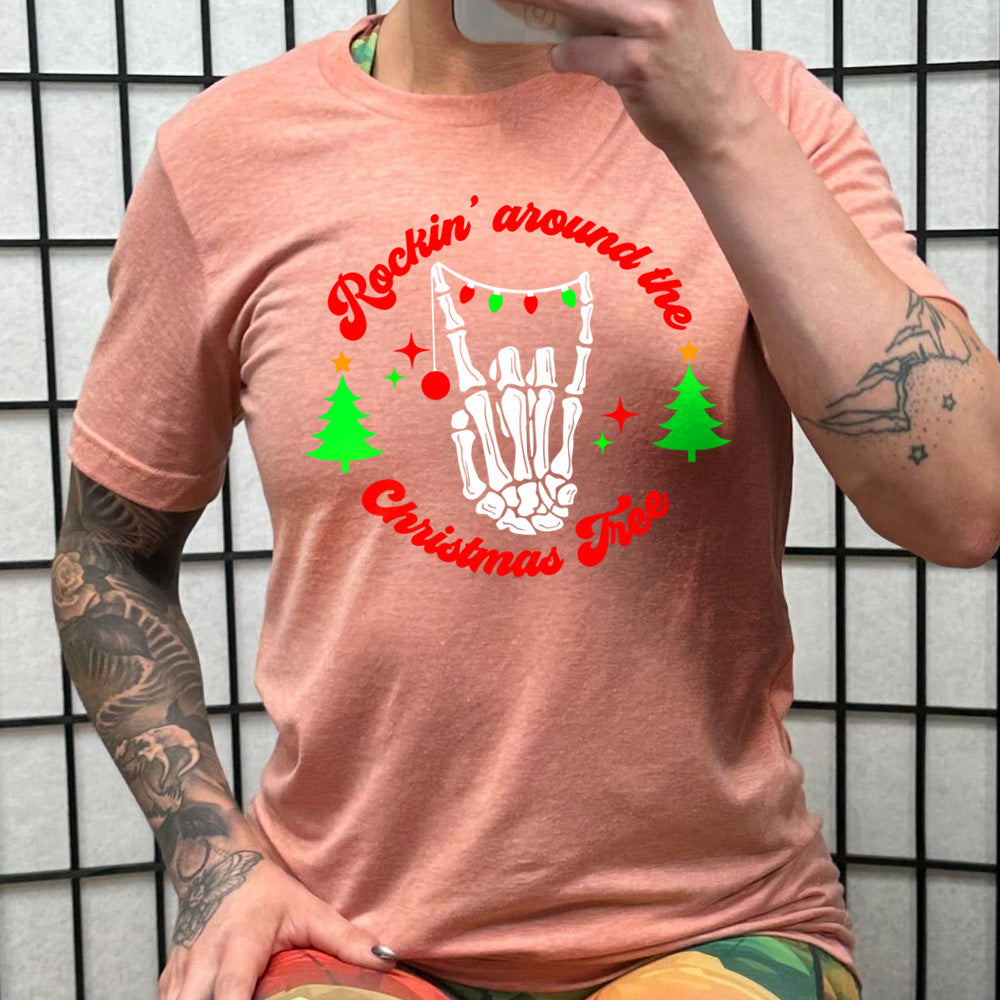 peach shirt with the text "Rockin' Around The Christmas Tree" on it