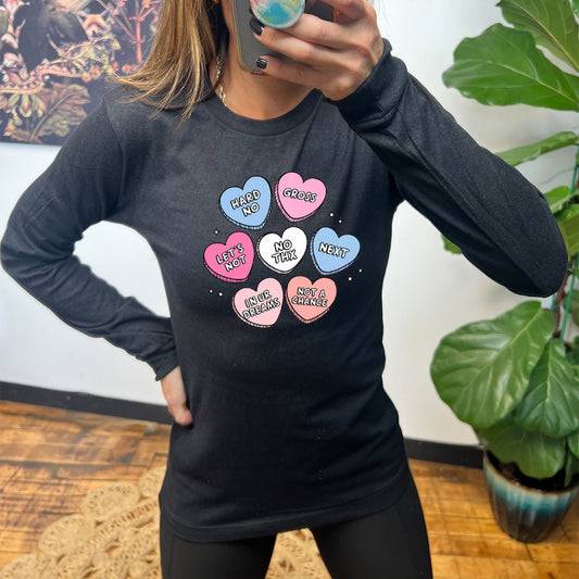 black long sleeve shirt with cartoon valentine heart candy graphics on it