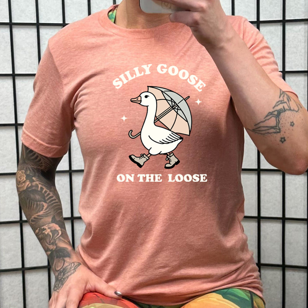 peach shirt with the text "Silly Goose On The Loose" on it