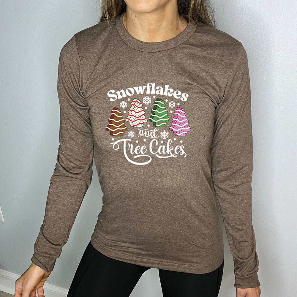 brown long sleeve shirt with Snowflakes & Tree Cakes graphics on it