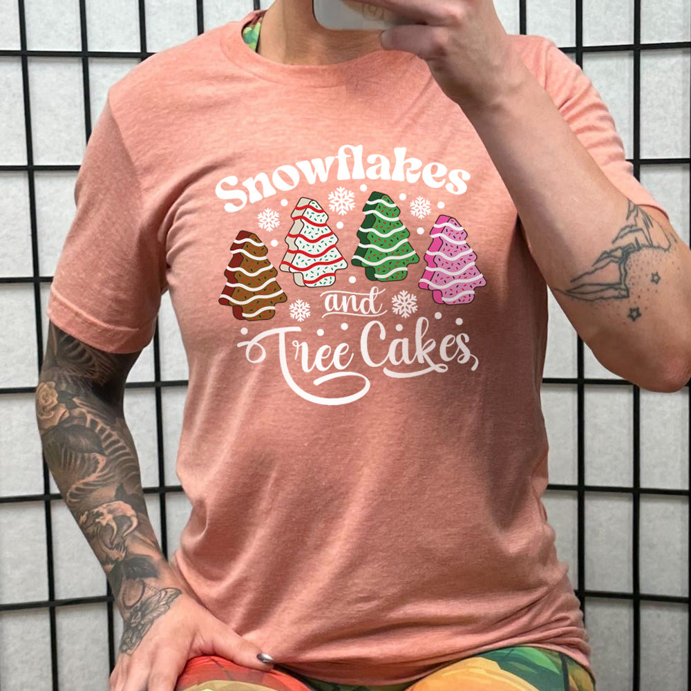 peach shirt with Snowflakes & Tree Cakes graphics on it