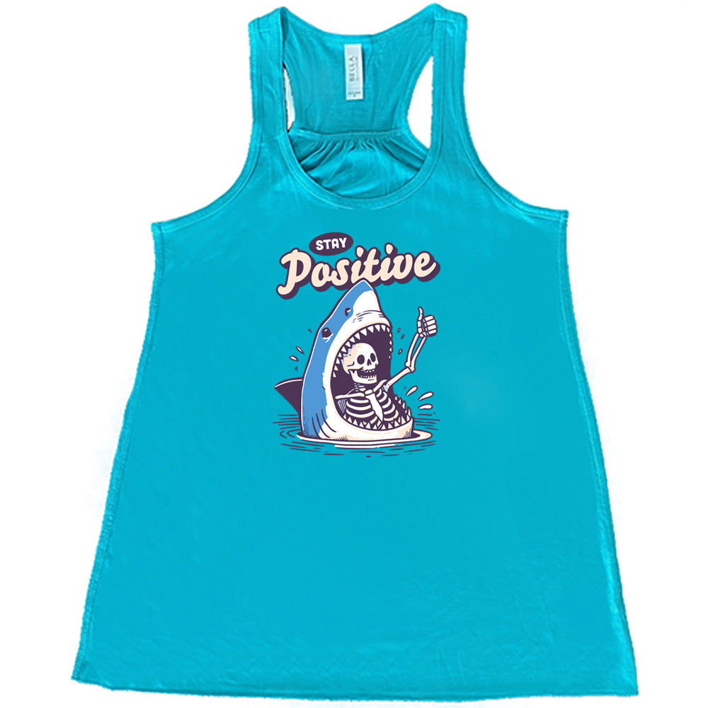 teal shirt with the text "Stay Positive" on it