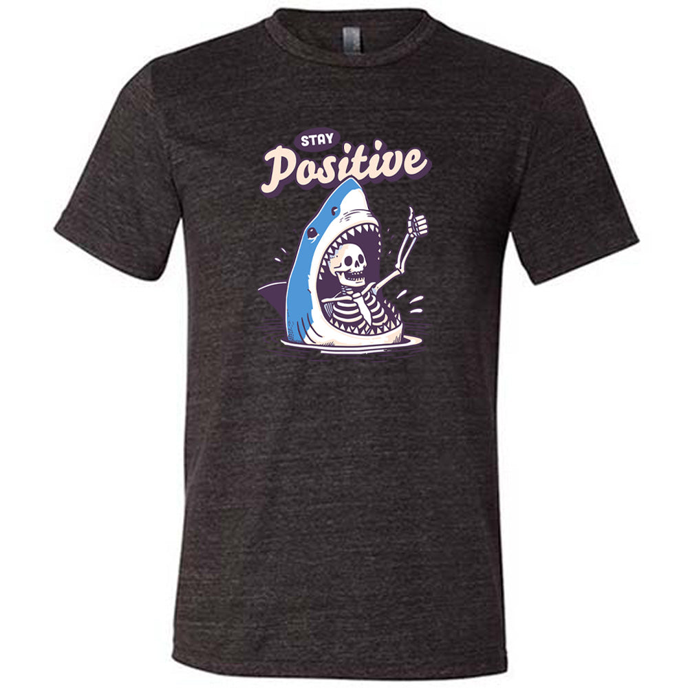 black shirt with the text "Stay Positive" on it