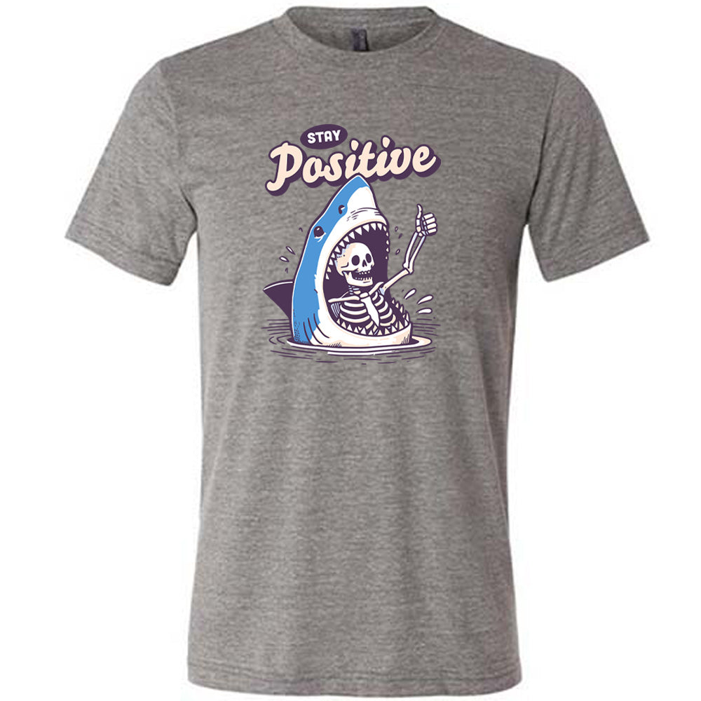 grey shirt with the text "Stay Positive" on it