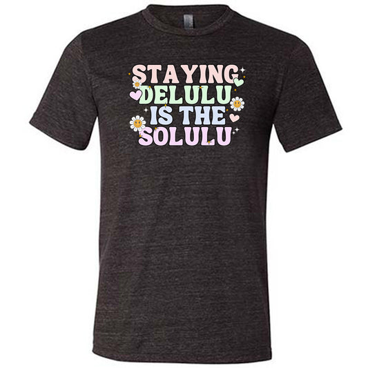 black shirt with the text "Staying Delulu Is The Solulu" on it