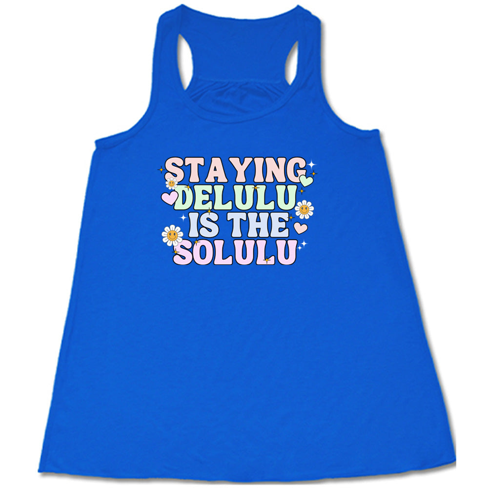 blue shirt with the text "Staying Delulu Is The Solulu" on it