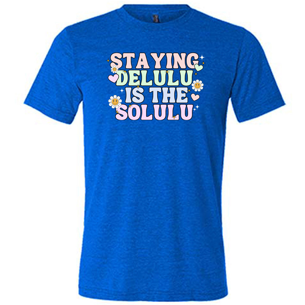 blue shirt with the text "Staying Delulu Is The Solulu" on it