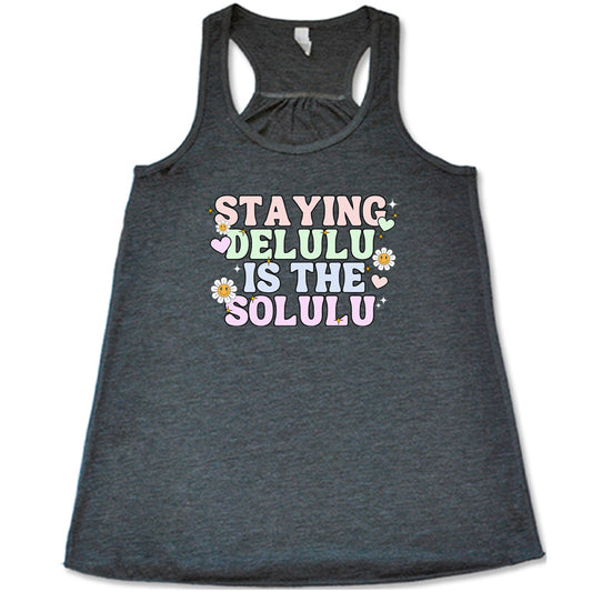 grey shirt with the text "Staying Delulu Is The Solulu" on it