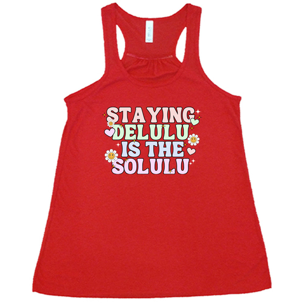 red shirt with the text "Staying Delulu Is The Solulu" on it