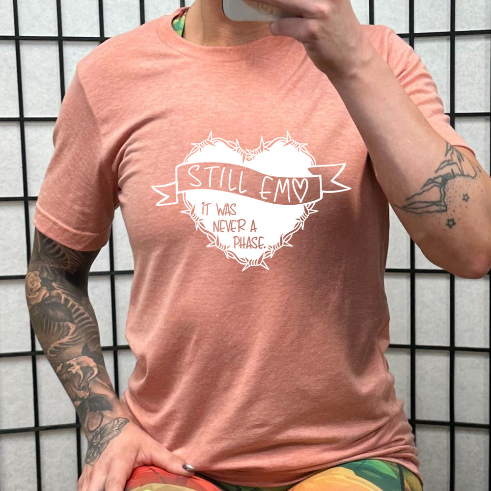 peach shirt with the text "Still Emo It Was Never A Phase" on it