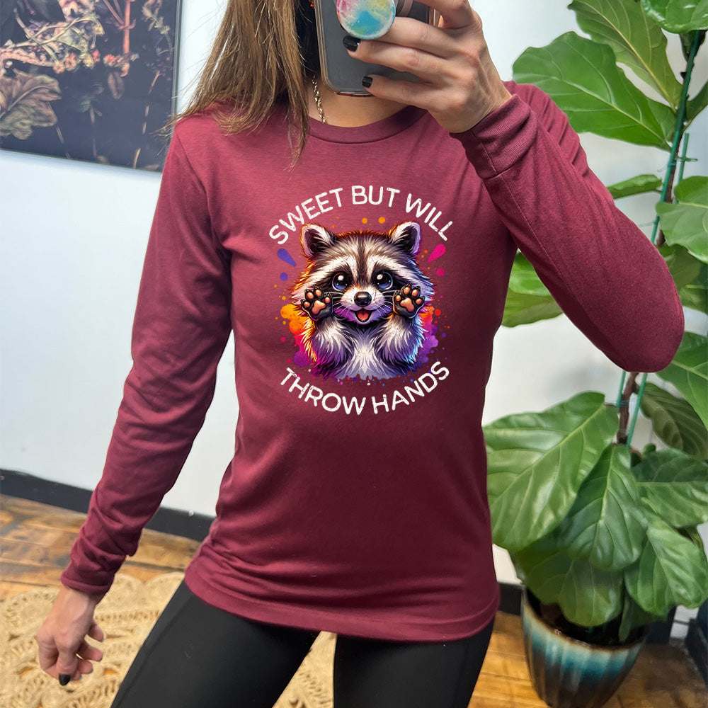 maroon shirt with the text "Sweet But Will Throw Hands" and a graphic of a raccoon on it