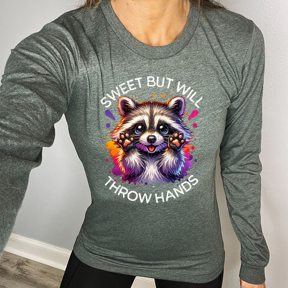 forest green shirt with the text "Sweet But Will Throw Hands" and a graphic of a raccoon on it