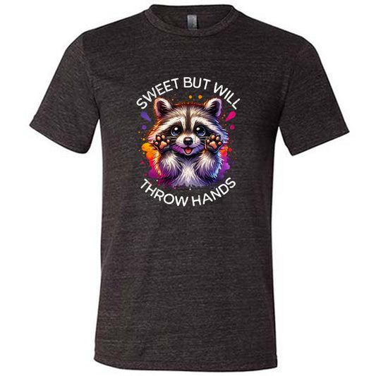 black shirt with the text "Sweet But Will Throw Hands" and a graphic of a raccoon on it