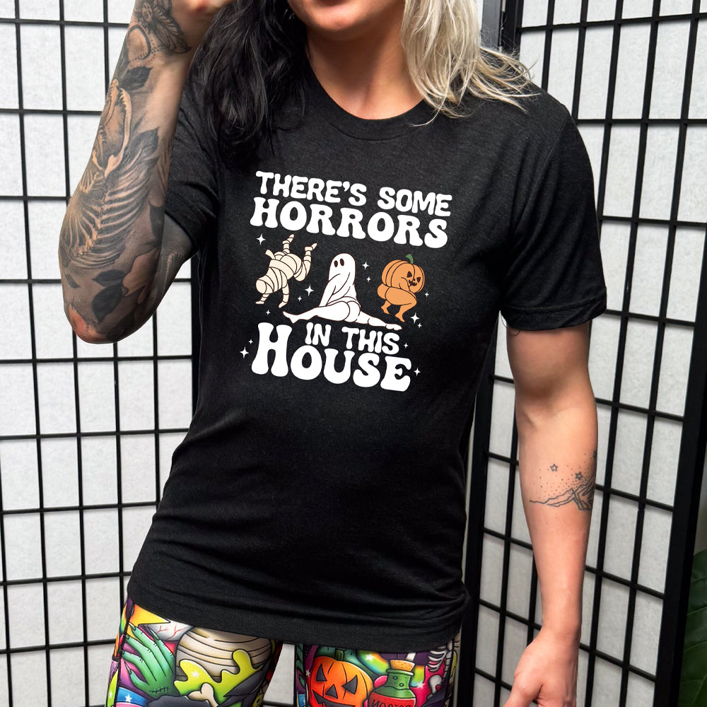 model wearing the black "There's Some Horrors In This House" shirt