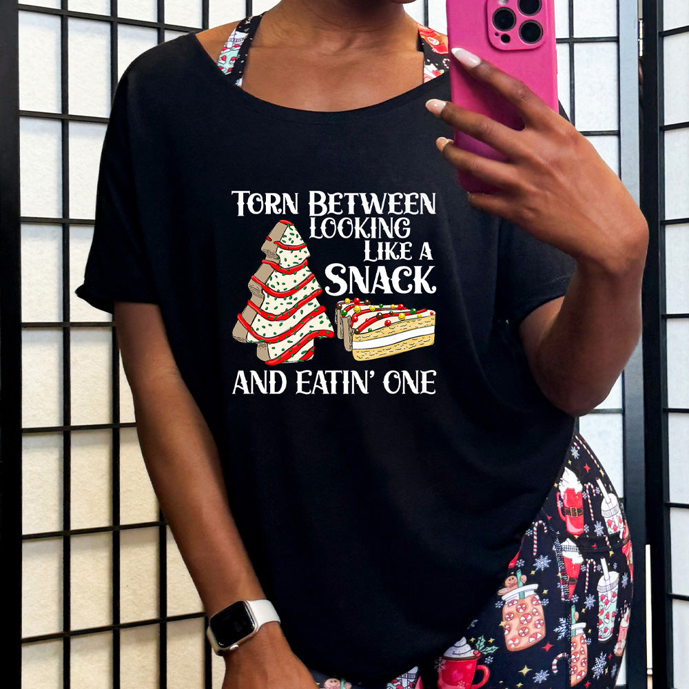 black slouchy shirt with the text "Torn Between Looking Like A Snack And Eating One" on it 