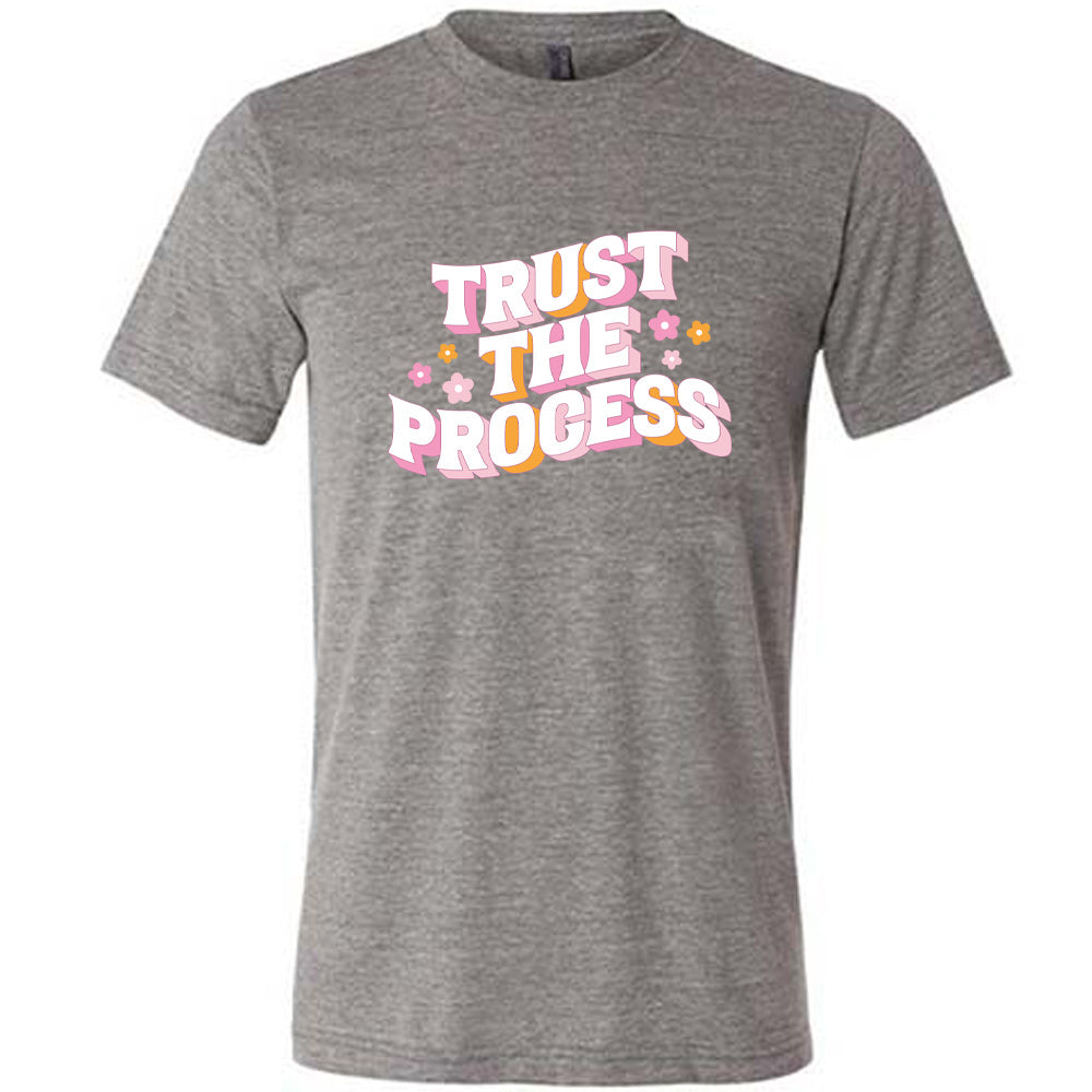 grey shirt with the text "Trust The Process" on it