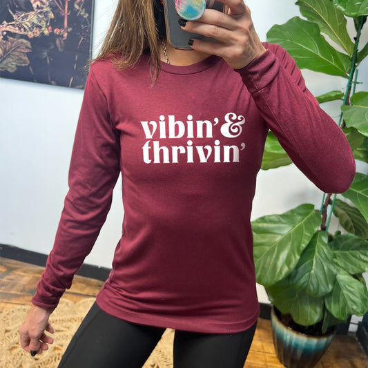 maroon long sleeve shirt with the text "Vibin & Thrivin" on it