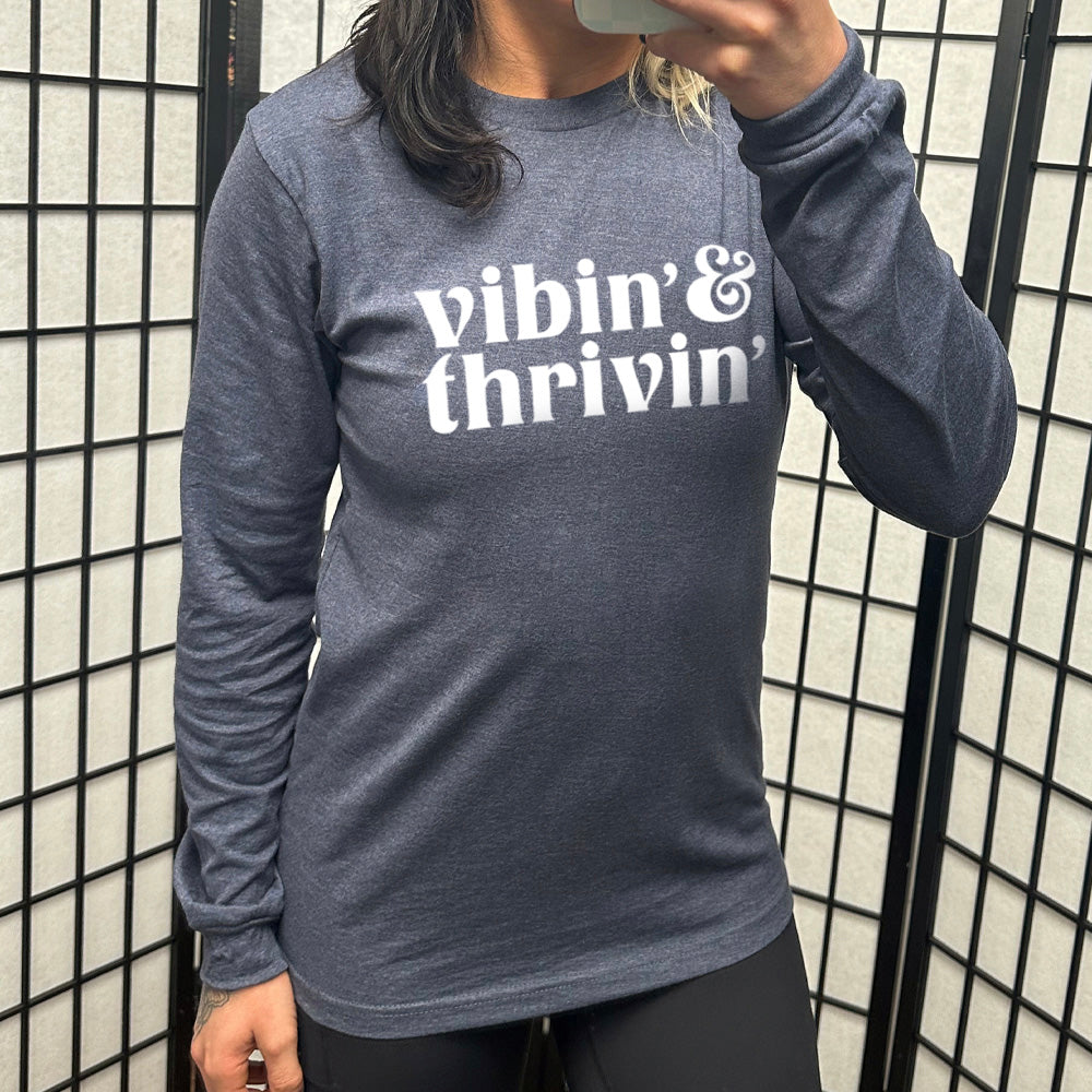 navy blue long sleeve shirt with the text "Vibin & Thrivin" on it