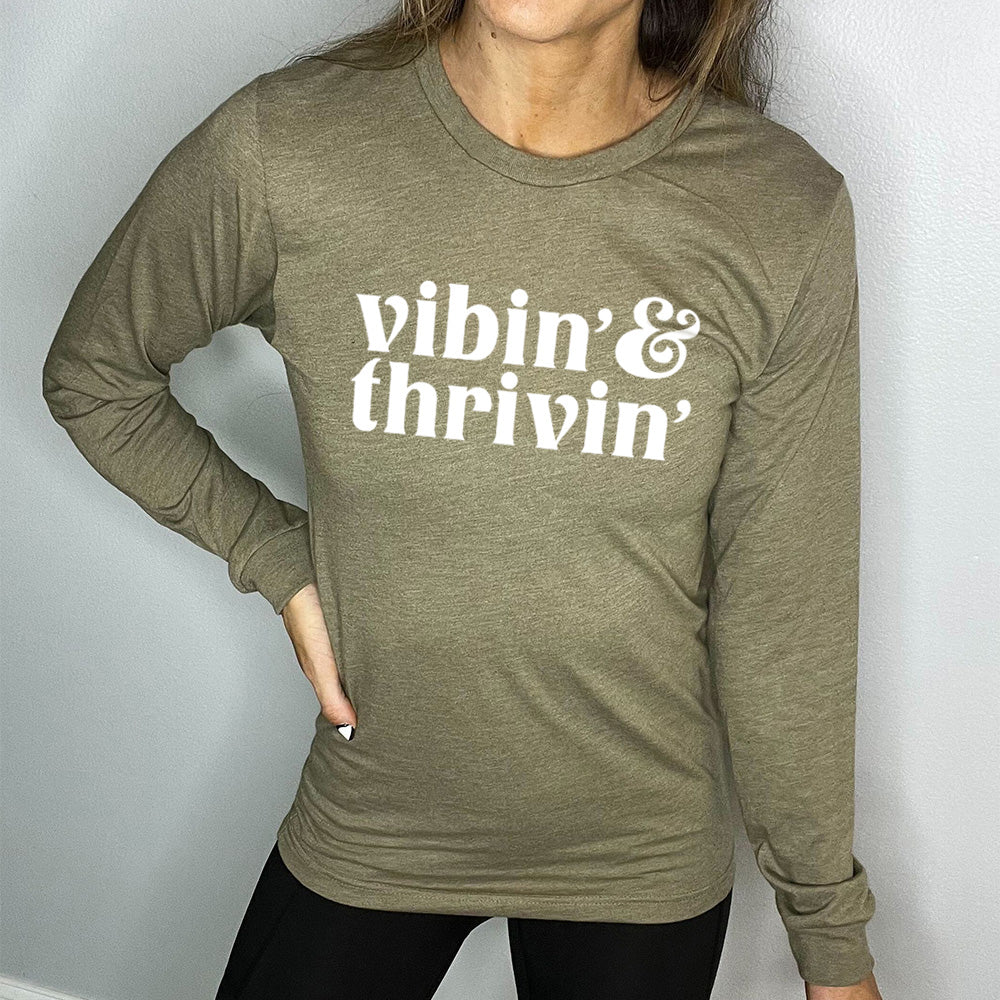 olive green long sleeve shirt with the text "Vibin & Thrivin" on it