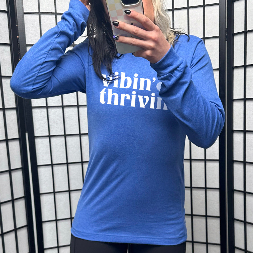 blue long sleeve shirt with the text "Vibin & Thrivin" on it