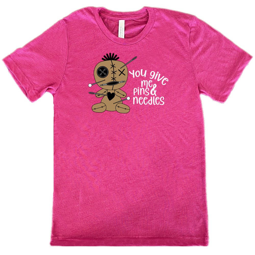 berry shirt with a voodoo doll graphic and the quote "You Give Me Pins And Needles" on it