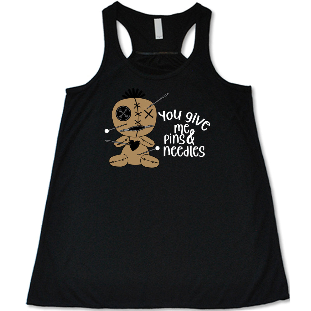 black shirt with a voodoo doll graphic and the quote "You Give Me Pins And Needles" on it