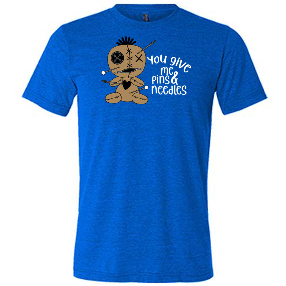 blue shirt with a voodoo doll graphic and the quote "You Give Me Pins And Needles" on it