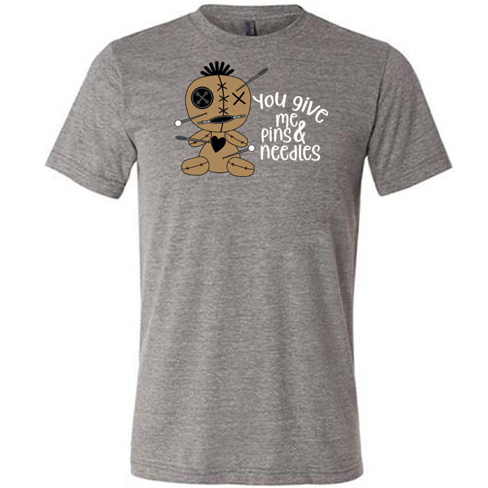 grey shirt with a voodoo doll graphic and the quote "You Give Me Pins And Needles" on it